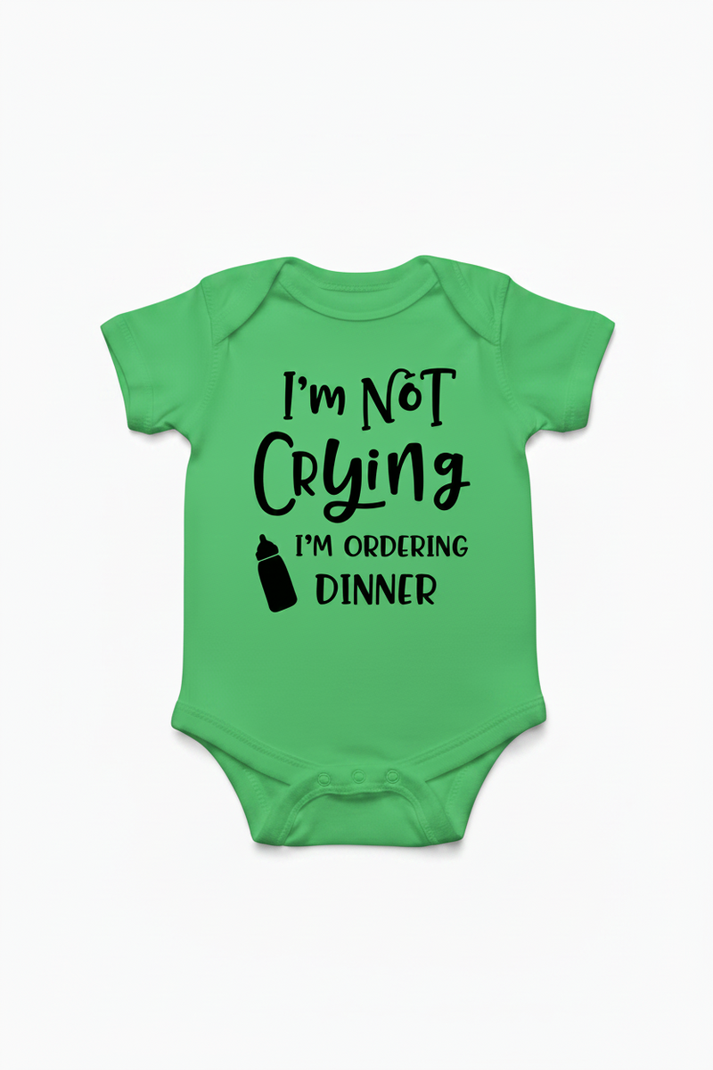 Green baby onesie with text 'I'm Not Crying I'm Ordering Dinner' on a white background