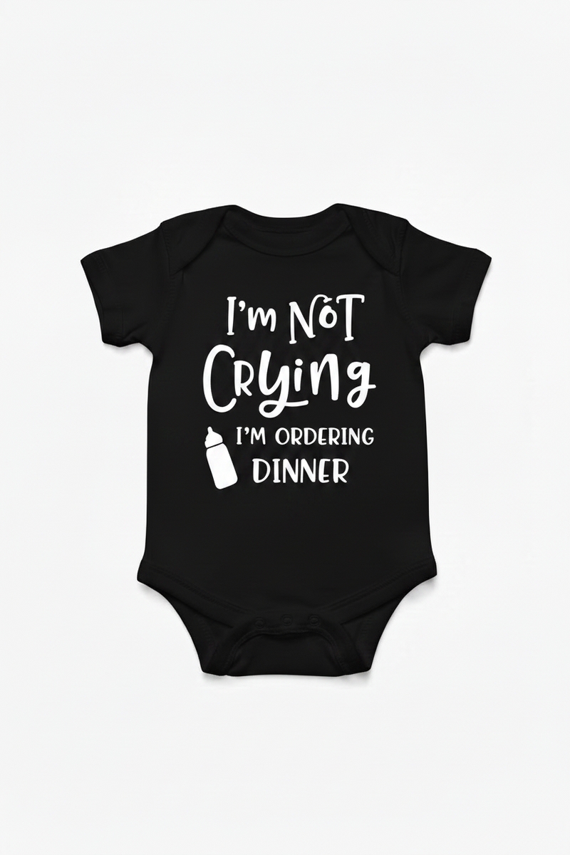 Black color baby onesie with text 'I'm Not Crying I'm Ordering Dinner' on a white background