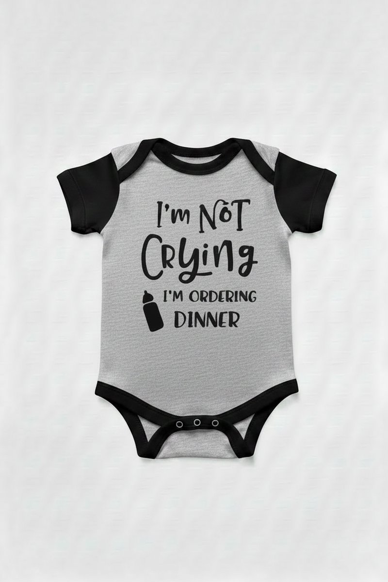 Gray with black color sleeve baby onesie with text 'I'm Not Crying I'm Ordering Dinner' on a white background