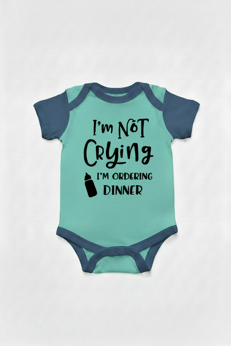 Teel and navy blue color baby onesie with text 'I'm Not Crying I'm Ordering Dinner' on a white background