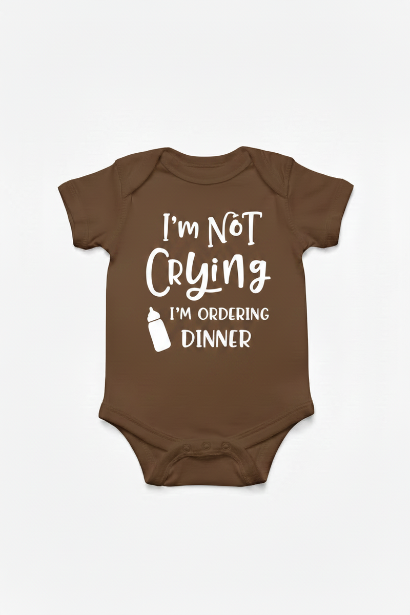 Brown color baby onesie with text 'I'm Not Crying I'm Ordering Dinner' on a white background