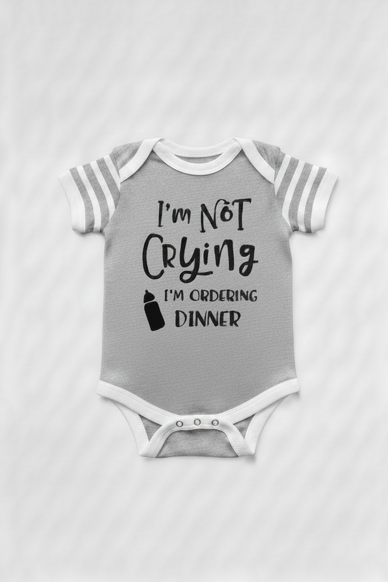 Gray with white stripes on sleeve baby onesie with text 'I'm Not Crying I'm Ordering Dinner' on a white background