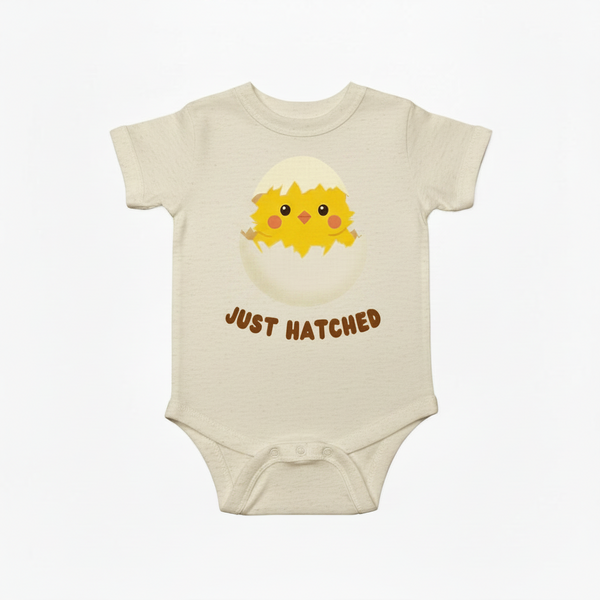 Baby onesie with a chick design and 'Just Hatched' text on a white background