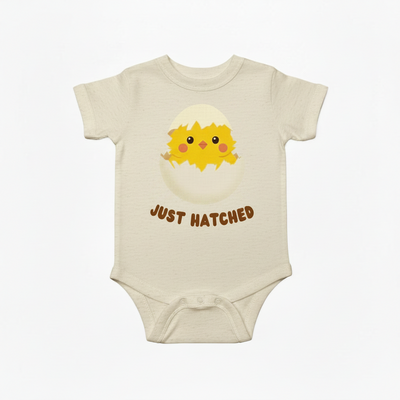 Baby onesie with a chick design and 'Just Hatched' text on a white background