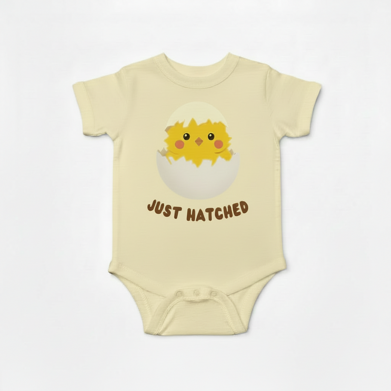 Natural color Baby onesie with a chick design and 'Just Hatched' text on a white background