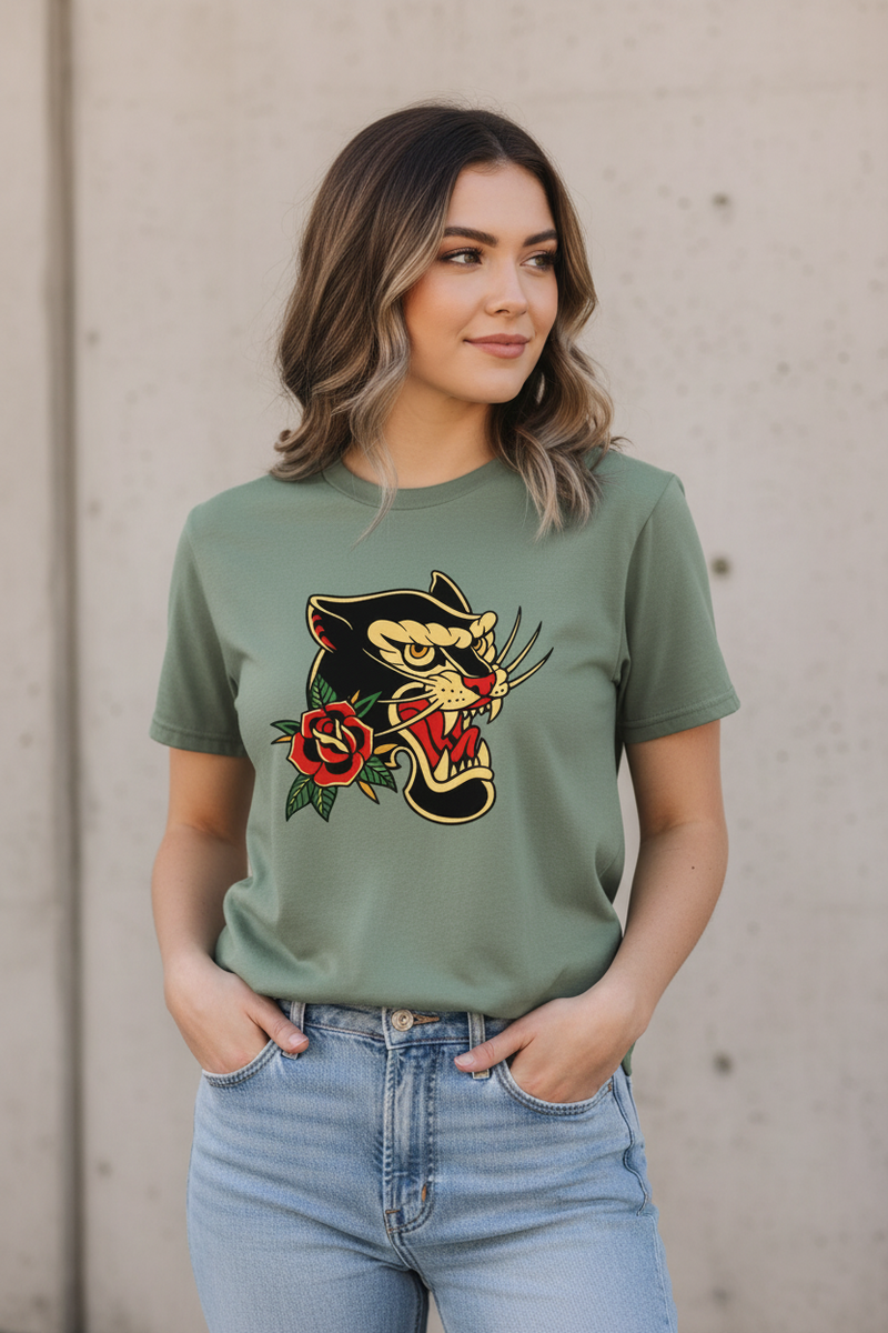 Woman wearing a green t-shirt with a graphic design against a plain background